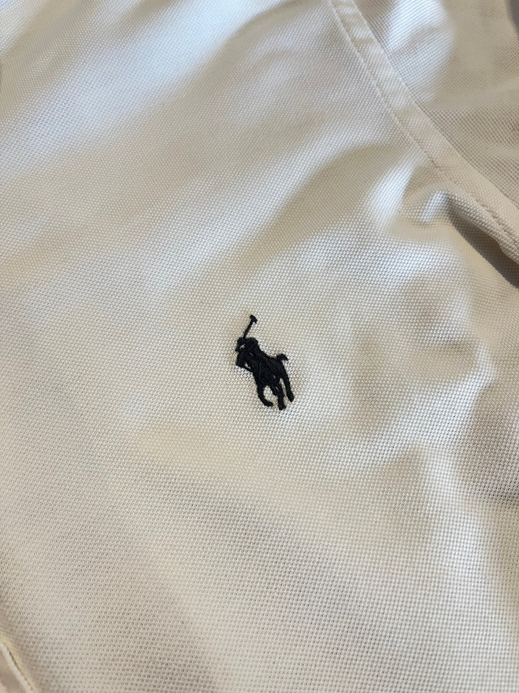 Polo Ralph Lauren embroidered pony logo detail on white fabric